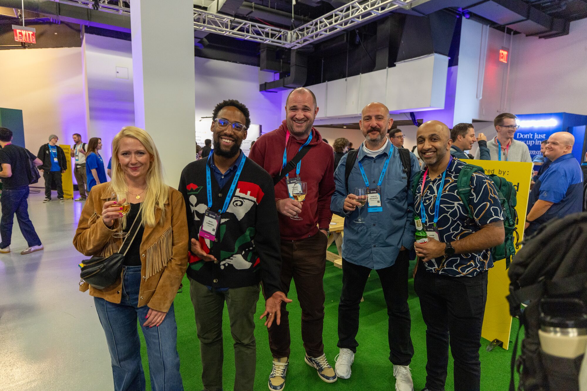 Attendees smiling for a group photo on the expo floor