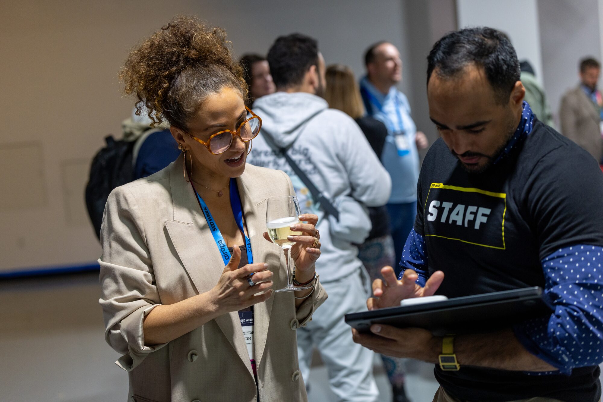 Staff member checking in an attendee on a tablet