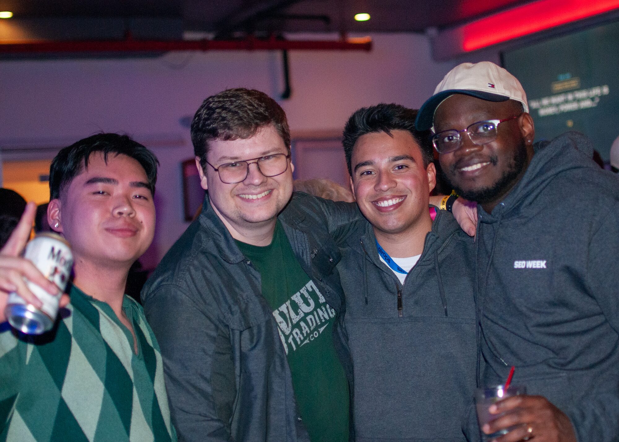 Group of attendees posing together at an evening event