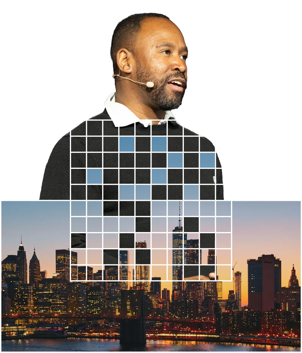 Speaker on stage wearing a headset mic, set against a Relevance grid over the Manhattan skyline at dusk